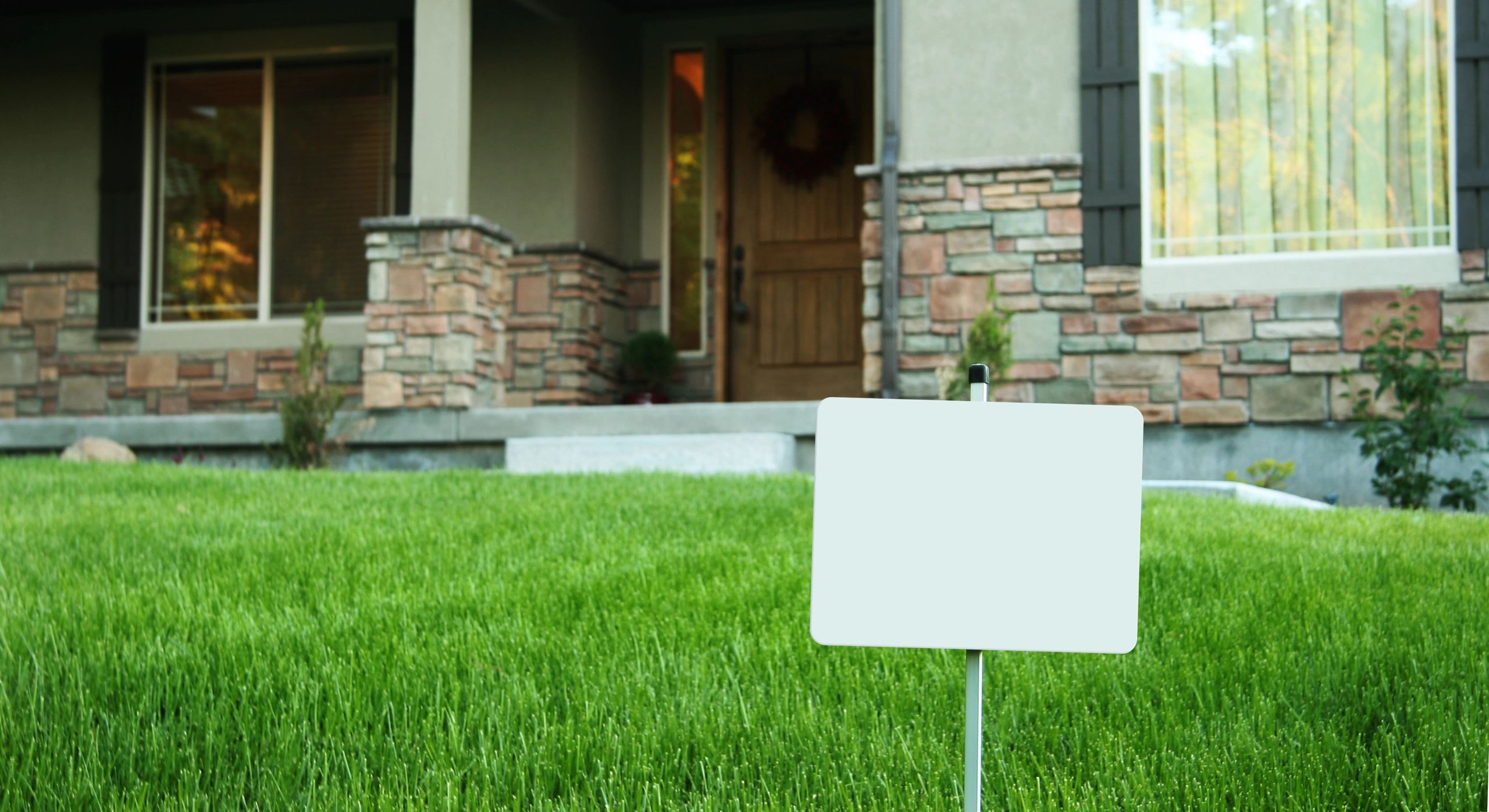 Home with a yard sign in the front yard